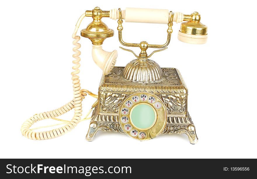 Isolated on the white antique gold retro phone. Isolated on the white antique gold retro phone