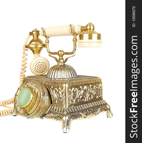 Isolated on the white antique gold retro phone. Isolated on the white antique gold retro phone