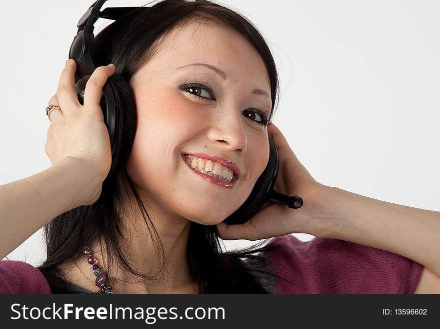 Attractive smiling woman with headphones on white background