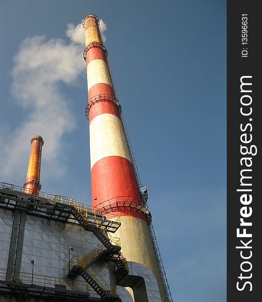 Old tall chimney painted white with red