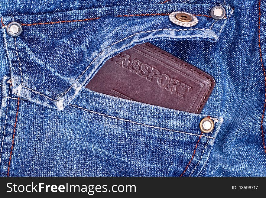 Brown passport in back blue jeans pocket. Brown passport in back blue jeans pocket