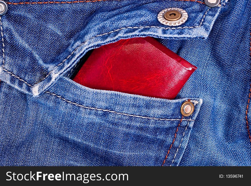 Red documents in back blue jeans pocket. Red documents in back blue jeans pocket