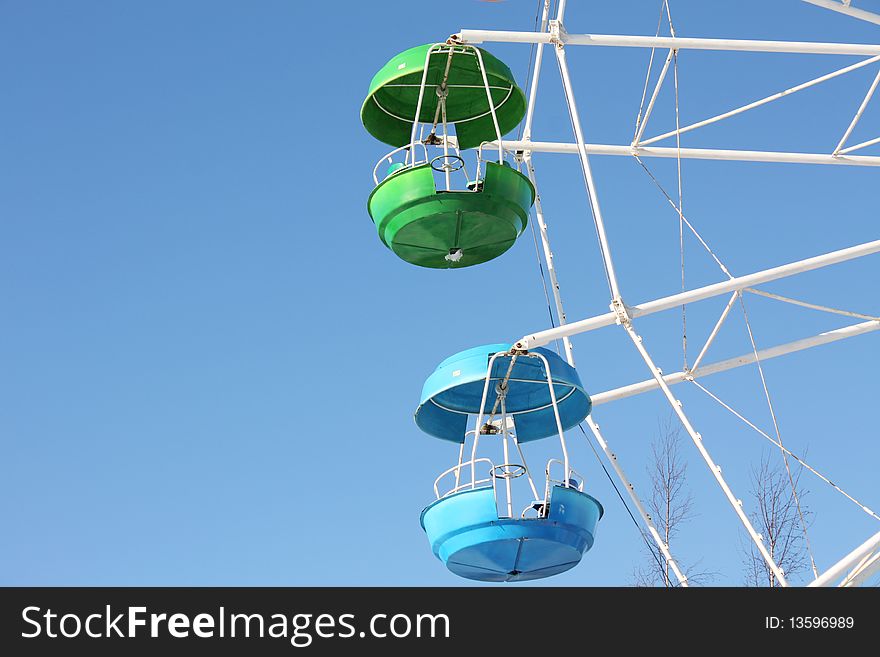 Green and blue cabins of Ferris wheel in St-Petersburg