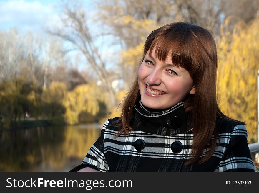 Young cute girl in autumn park