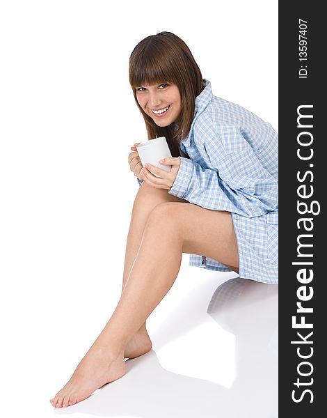 Smiling female teenager in pajamas with cup of tea for breakfast. Smiling female teenager in pajamas with cup of tea for breakfast