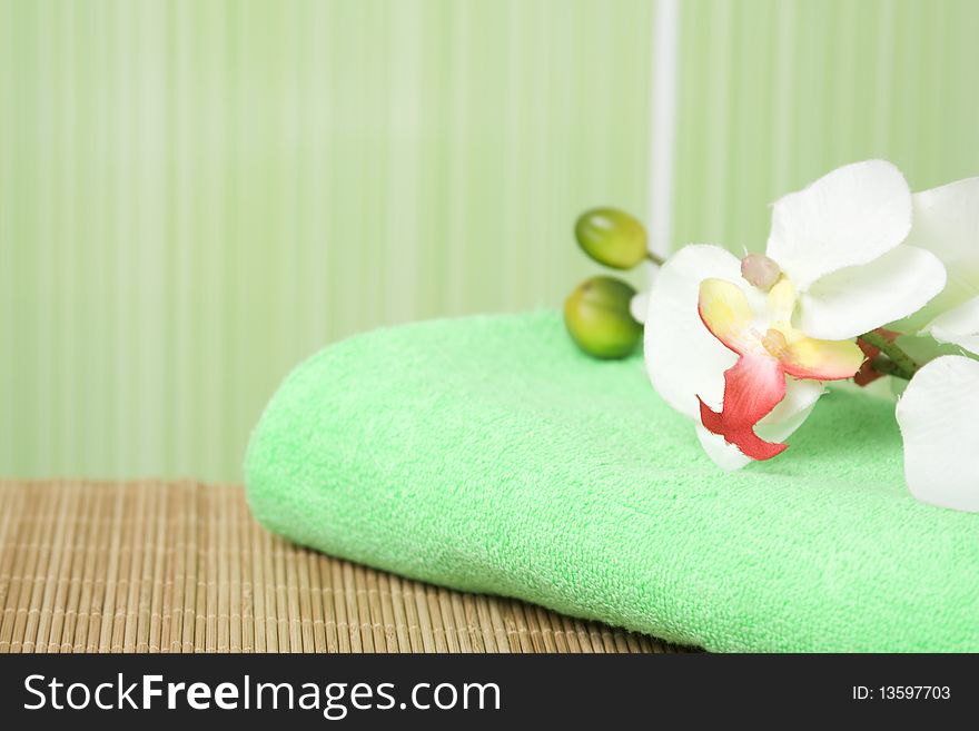 Bathroom in green tones. Towel green it is a white orchid. Bathroom in green tones. Towel green it is a white orchid