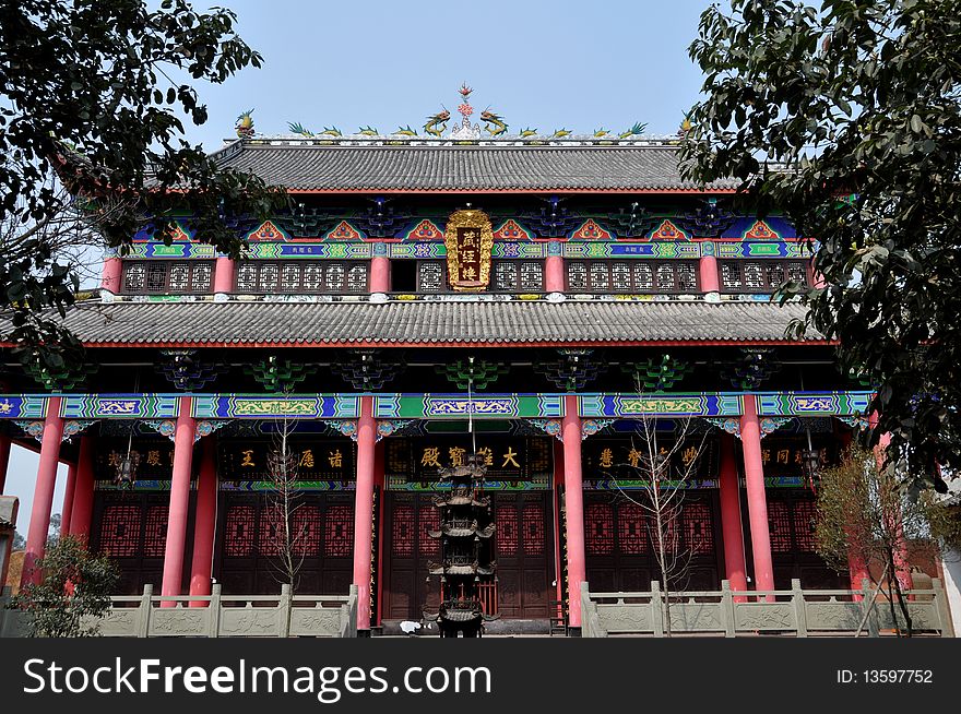 Colourfully painted Cang Jing Luo hall with its three tiers featuring balconies, painted designs, and dragon rooftop figures at Yuan Si Buddhist temple in Pengzhou, China. Colourfully painted Cang Jing Luo hall with its three tiers featuring balconies, painted designs, and dragon rooftop figures at Yuan Si Buddhist temple in Pengzhou, China.