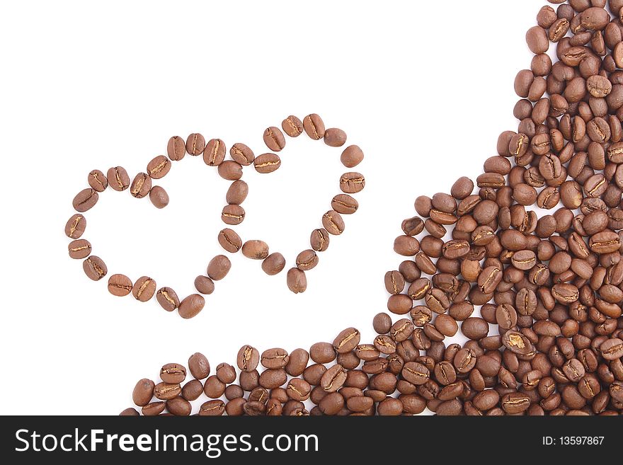 Two coffee heart on white background (close up). Two coffee heart on white background (close up)