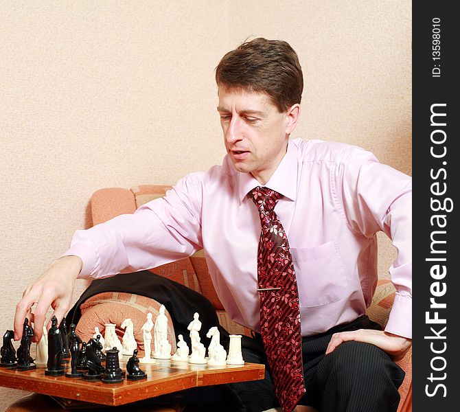 An image of a young man playing chess. An image of a young man playing chess