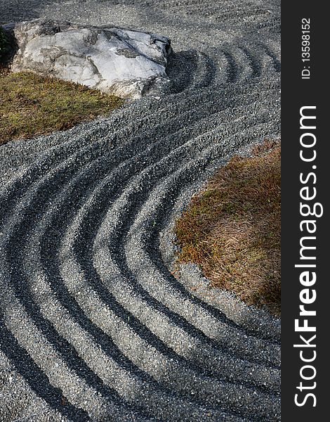 Some detail of a Zen garden in Kyoto.  These gardens typically contain sand or gravel and bare stones. Some detail of a Zen garden in Kyoto.  These gardens typically contain sand or gravel and bare stones.