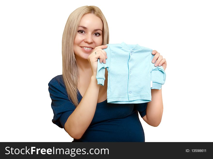 Pregnancy, The future mum holds a children's jacket. Pregnancy, The future mum holds a children's jacket