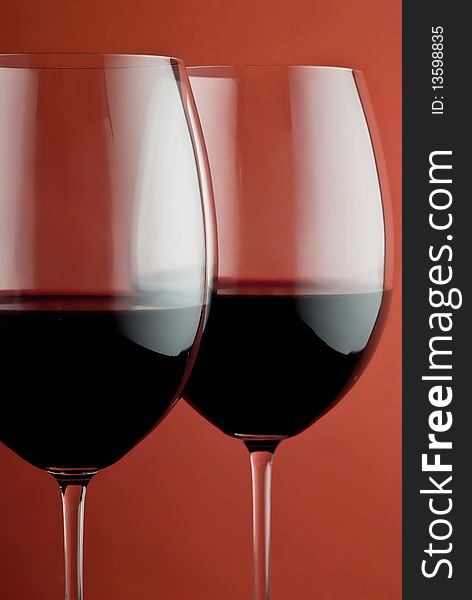 Photo of a wine glass on a red background. Photo of a wine glass on a red background