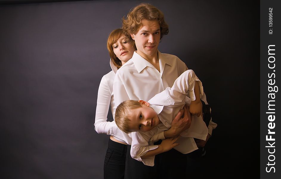 Portrait of a family - parents and their son, father holding boy in his arms. Portrait of a family - parents and their son, father holding boy in his arms