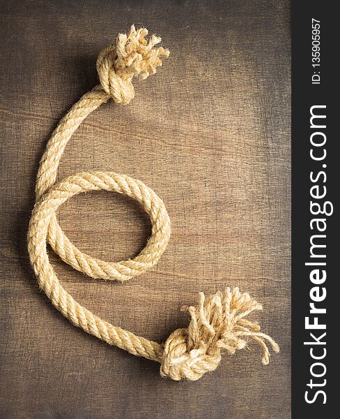 Ship rope at wooden background