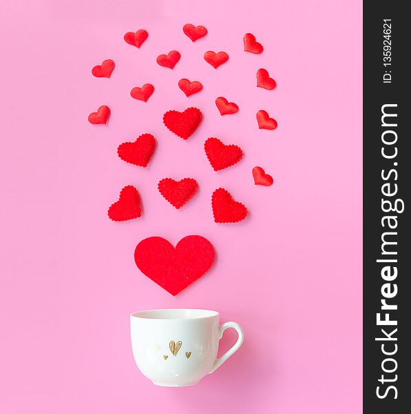 Valentine`s Day with red hearts, cup coffee on pink background, copy space Valentines day Concept. Flat lay