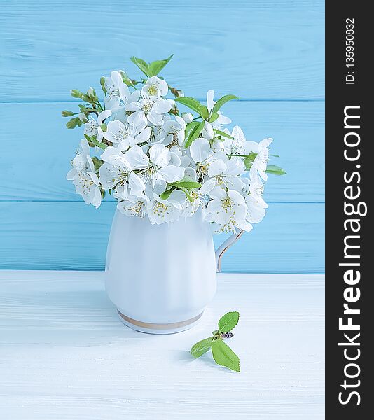 Blooming cherry vase on a wooden background romance springtime fresh march greeting. Blooming cherry vase on a wooden background romance springtime fresh march greeting