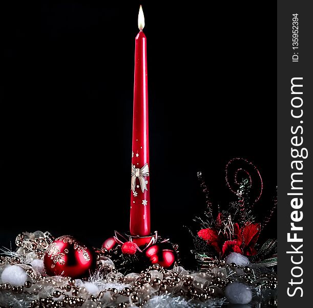 Candle and Christmas composition on a black background