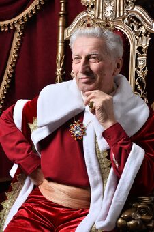 Free Portrait Of Confident Senior Man In Red Cloak Stock Photos - 135983213