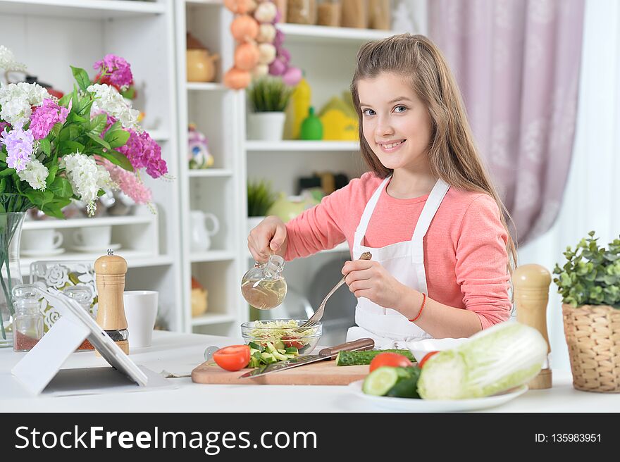 Portrait of young girl cooking in kitchen at home