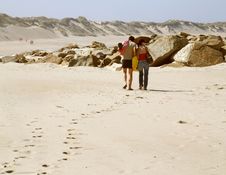 Couple Walking Along A Beach Stock Images Couple Walking Along A Beach Stock Images