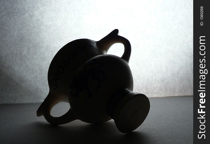 Antique/ancient small vase in backlight silhouette. Antique/ancient small vase in backlight silhouette