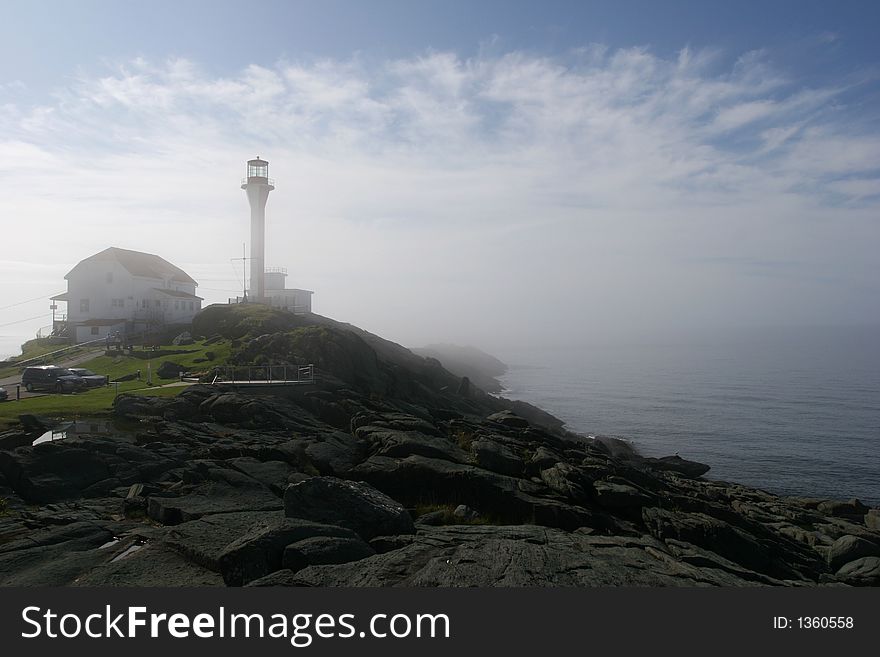 Lighthouse on top of a hill in the fog of a fall morning. Lighthouse on top of a hill in the fog of a fall morning