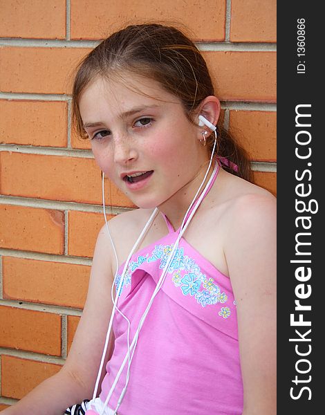 Beautiful girl listening and singing to music player