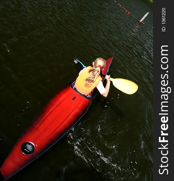 A lake in denmark with a blond girl on a kayak. A lake in denmark with a blond girl on a kayak