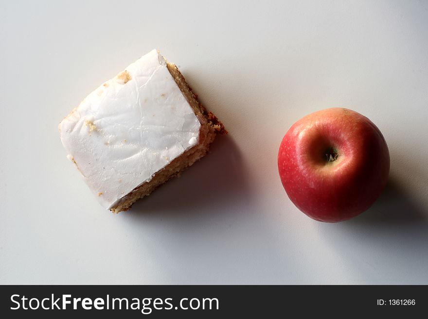 Close up picture of an apple and cake