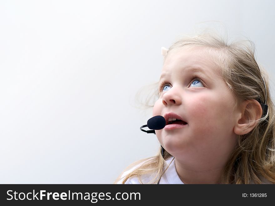 Young girl isolated on white with phone headset. Young girl isolated on white with phone headset