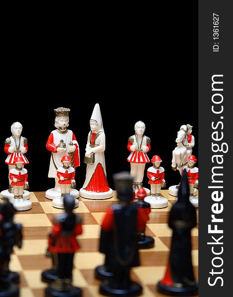 Ivory chess pieces with black chess pieces out of focus