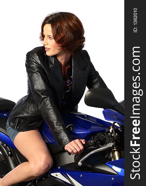 A brunette girl sitting on a blue motorcycle with black leather jacket. A brunette girl sitting on a blue motorcycle with black leather jacket