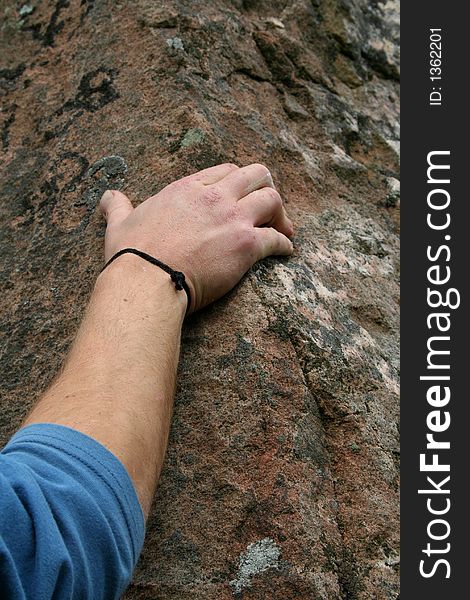 Detail of rock climber's hand on stone. Detail of rock climber's hand on stone