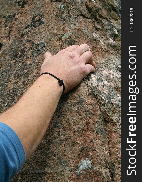 Detail of rock climber's hand on stone. Detail of rock climber's hand on stone