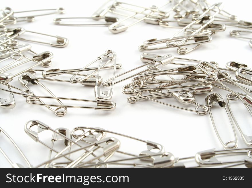 Safety pins on a white background