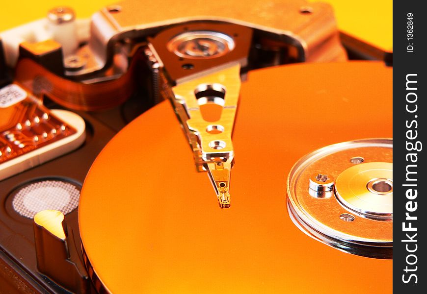 Harddisk closeup with yellow reflection. Harddisk closeup with yellow reflection