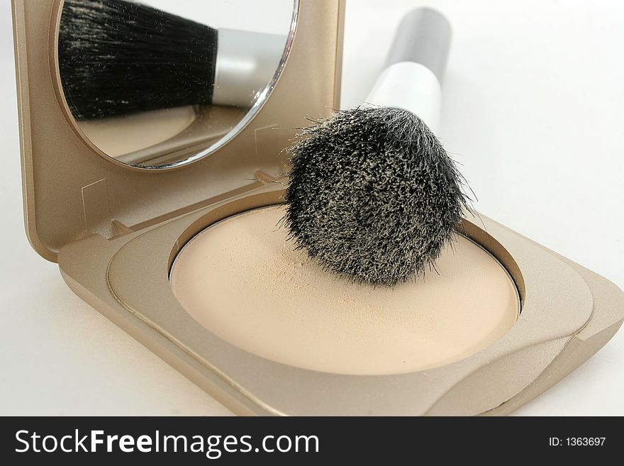 Focus on powder. Brush laying on compact. Focus on powder. Brush laying on compact.
