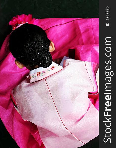 Korean girl dressed in a beautiful pink traditional costume (hanbok). Korean girl dressed in a beautiful pink traditional costume (hanbok)