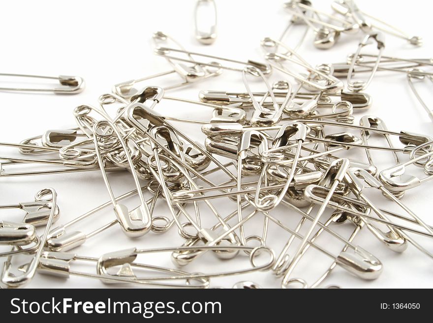 Safety pins on a white background