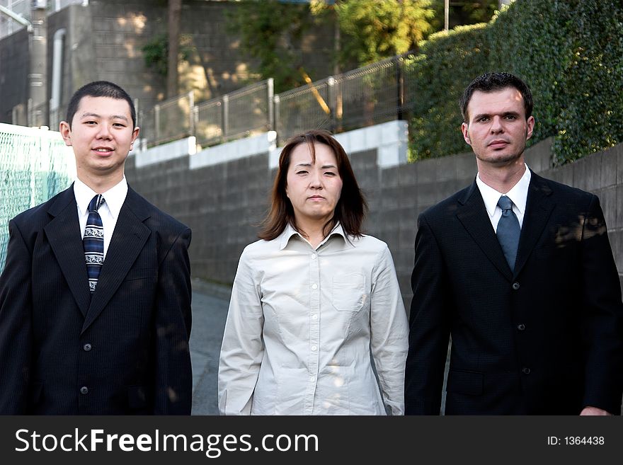 American and asian business people walking on the street. American and asian business people walking on the street