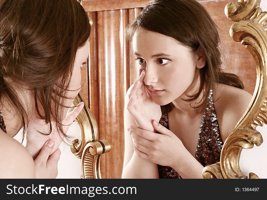Auburn-haired girl, young woman in front of a mirror. Auburn-haired girl, young woman in front of a mirror