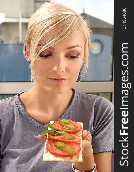 Woman Eating A Tomato Sandwich