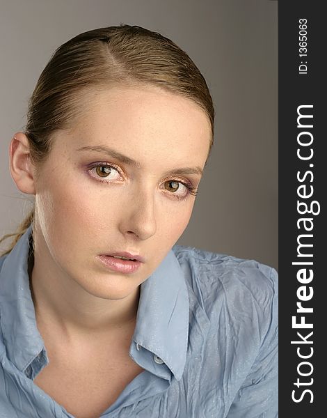 Young girl, woman in a blue blouse-portrait