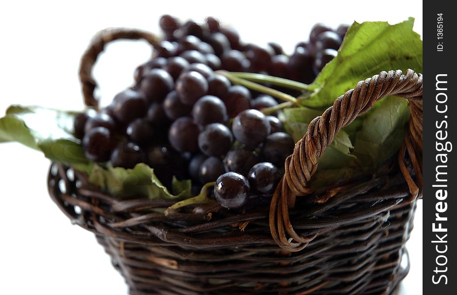 Grapes in the basket on the white background