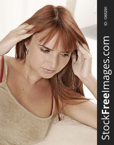 Red-haired young girl, woman with a headache