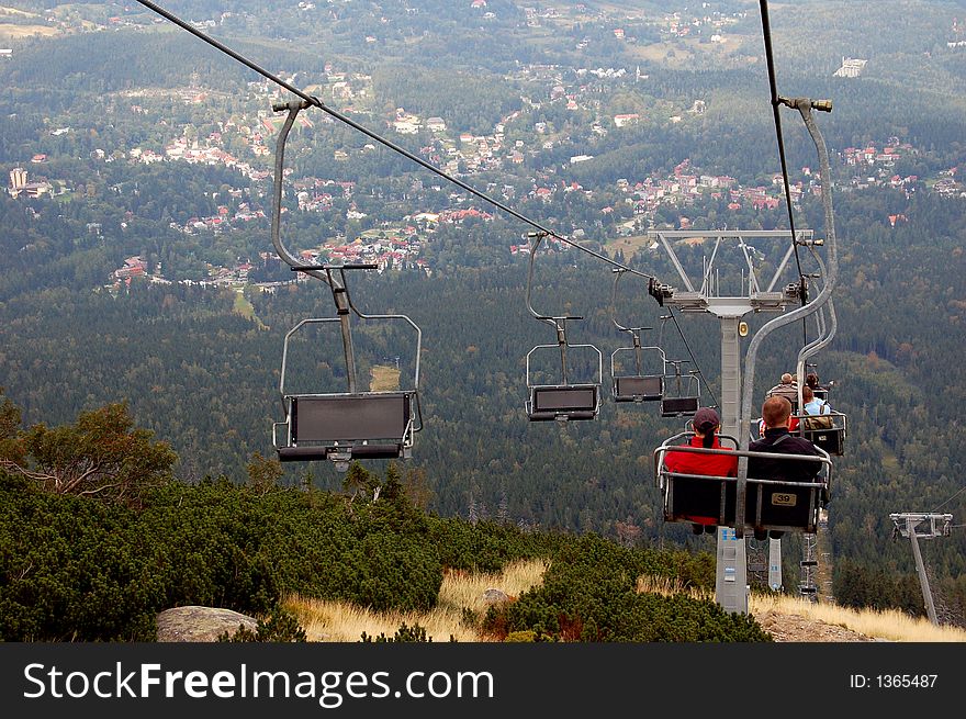 Chairlift and view from the mountain on the city below.