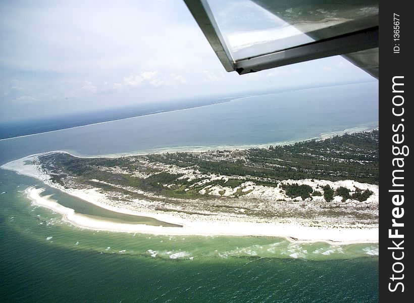 This is the north end of the St. Joseph Peninsula showing the old beaches which reach as much as thirty feet in height.  It is the northern extension of the Cape San Blas and the view is to the east towards the town of Saint Joe Beach.  Part of the plane wing and window are in view. This is the north end of the St. Joseph Peninsula showing the old beaches which reach as much as thirty feet in height.  It is the northern extension of the Cape San Blas and the view is to the east towards the town of Saint Joe Beach.  Part of the plane wing and window are in view.