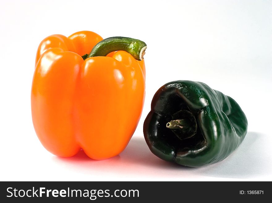 Still life with two peppers, one yellow, one green