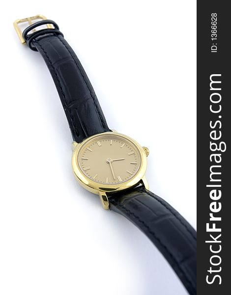 A female golden wrist watch with leather wristlet.