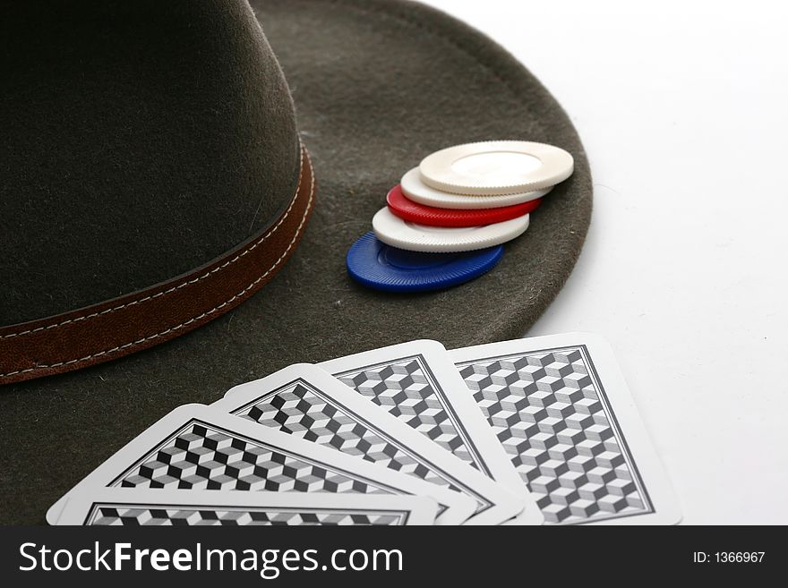 Cowboy hat, poker chips, and playing cards on white background. Cowboy hat, poker chips, and playing cards on white background
